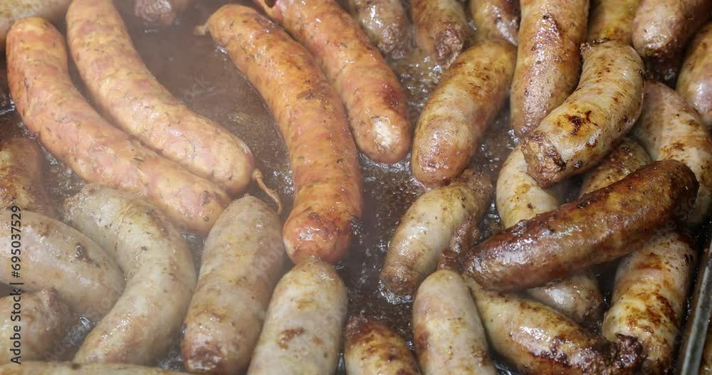 Close-up of homemade sausages fried in boiling oil in a hot frying pan. 4k video Close-up of homemade sausages fried in boiling oil in a hot frying pan. 4k video