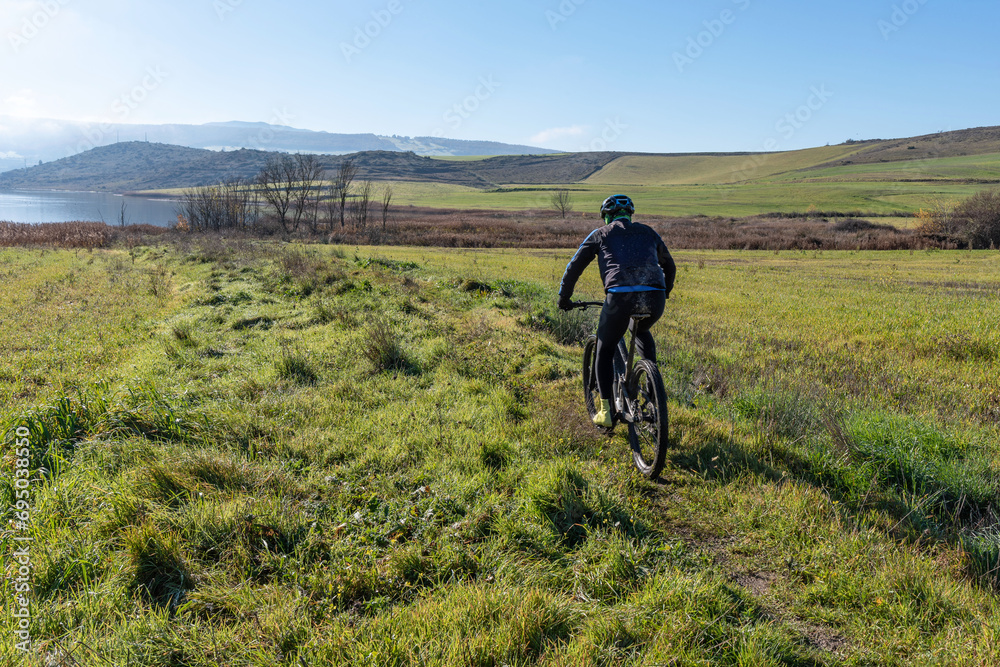 Obraz premium Mountain bike route through the green meadows