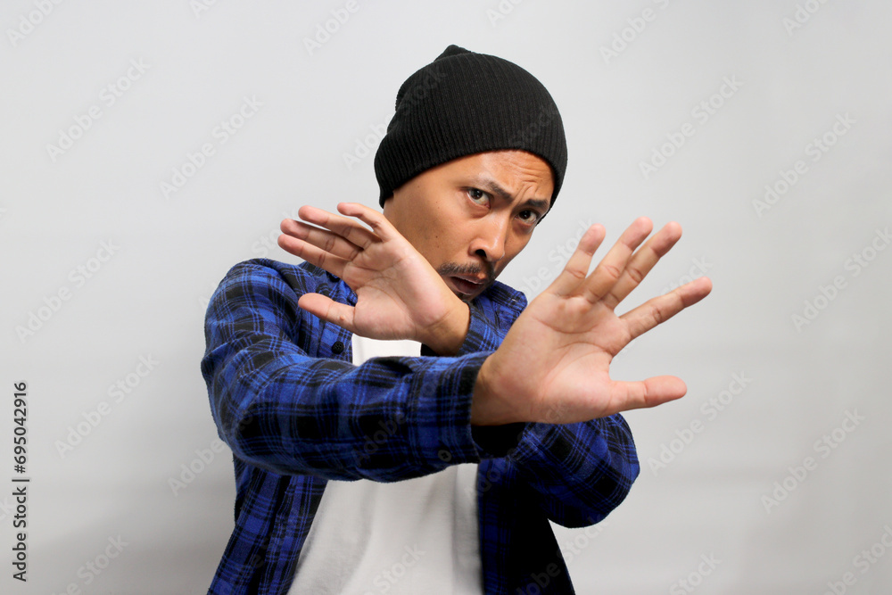 Ew. It's so gross. Displeased young Asian man, dressed in a beanie hat and casual shirt, wears a disgusted expression while visibly repulsed by something, standing against a white background Ew. It's so gross. Displeased young Asian man, dressed in a beanie hat and casual shirt, wears a disgusted expression while visibly repulsed by something, standing against a white background