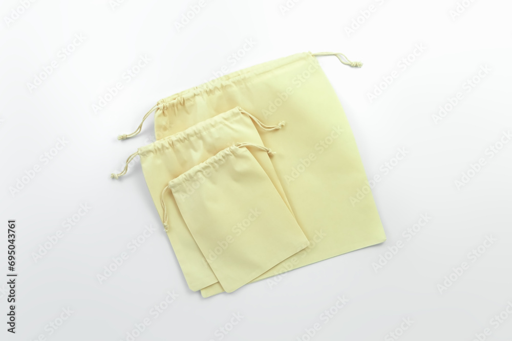three different sizes empty cotton bags on a white background. eco friendly storage concept three different sizes empty cotton bags on a white background. eco friendly storage concept