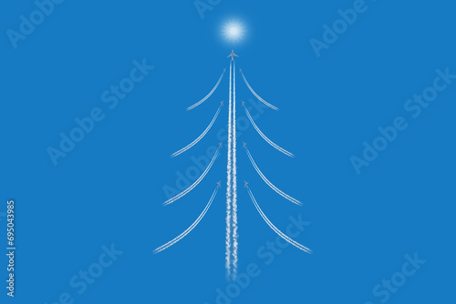Christmas tree like figure made of airplanes trailes on blue sky  background