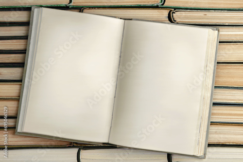 Wallpaper Mural Opened old book with blank pages on a stack of paper books Torontodigital.ca