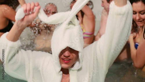 Guy in rabbit costume dancing at pool with five other young gays photo