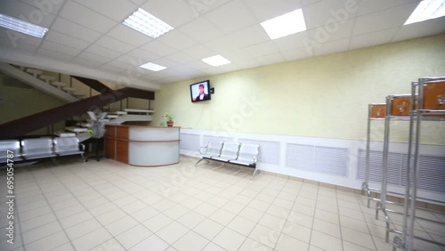 Waiting hall with seats and cloakroom in modern office center photo