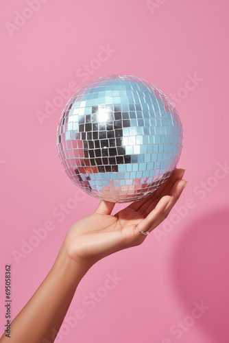 a person's hand holding a disco ball