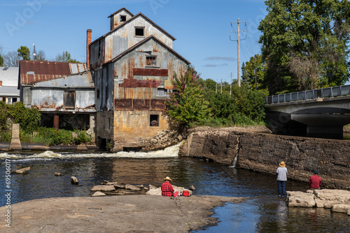 People fishing besides an old lumber mill Rislon Ontario photo