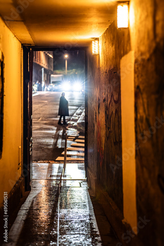 Fototapeta Naklejka Na Ścianę i Meble -  Picturesque Streets of Old Lyon at Night, France. Mysterious Figure in Lyon Alleyway at Night.