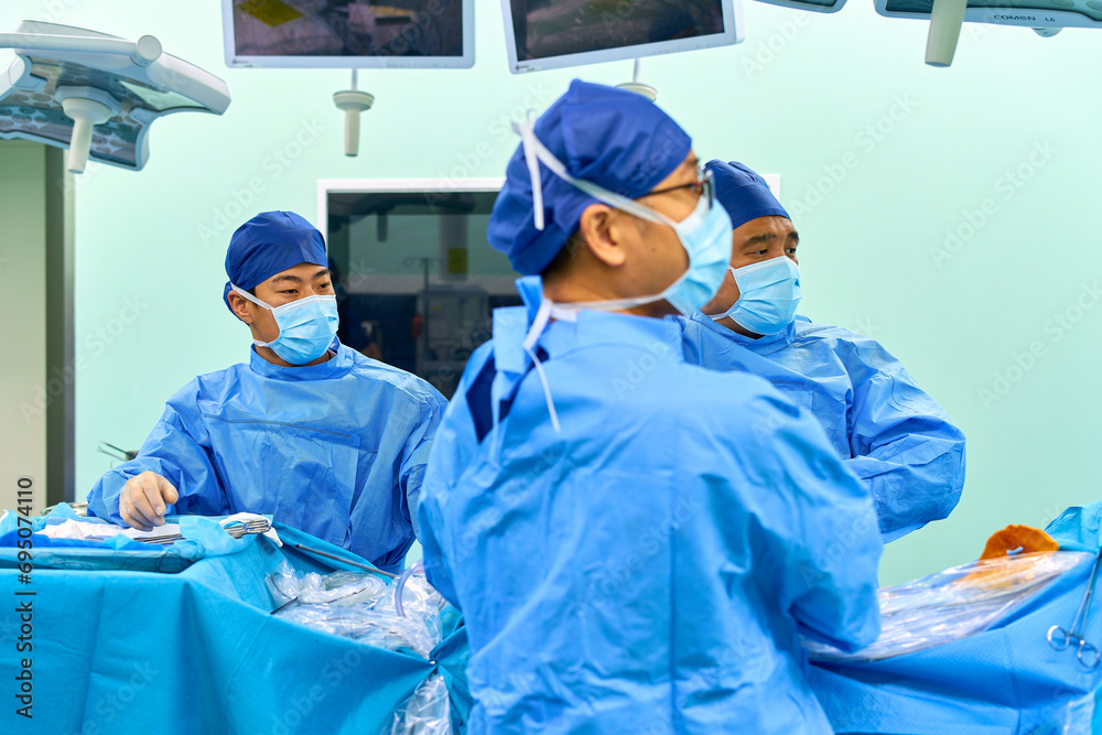 Asian surgeons work in a modern operating room Asian surgeons work in a modern operating room