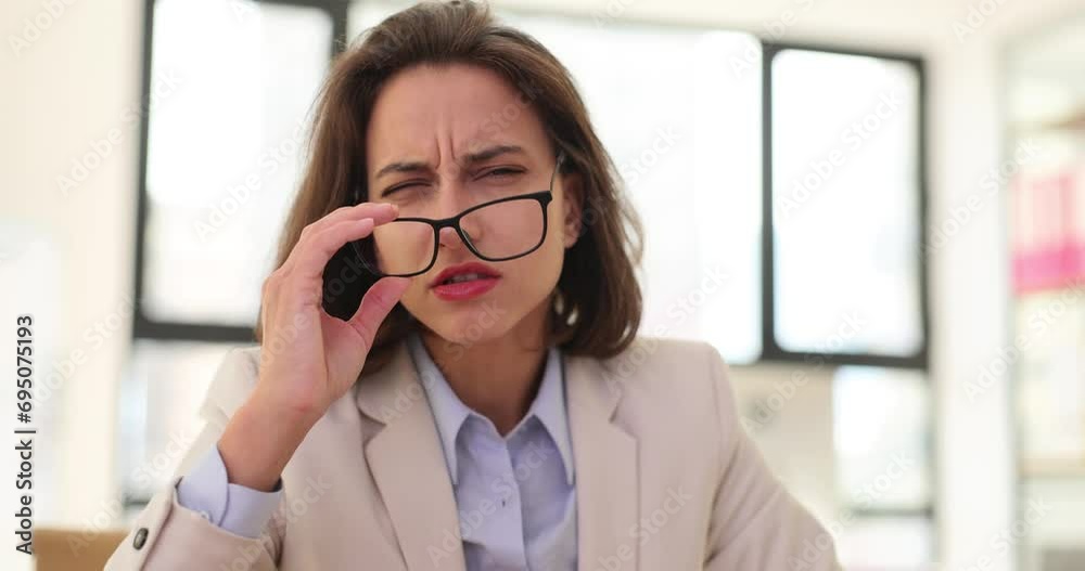 Woman takes off glasses and sees poorly at workplace Woman takes off glasses and sees poorly at workplace