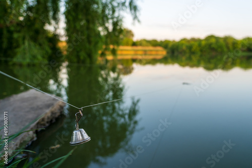 A bell on a fishing line. Background with selective focus and copy space