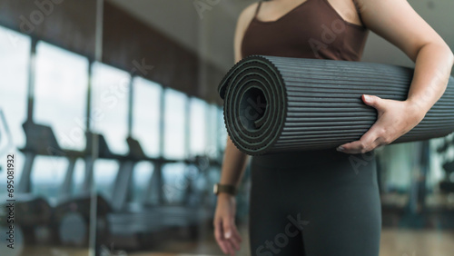 woman holding yoga mat prepare to meditation. © mojo_cp