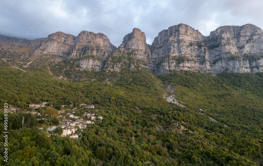 Drone scenery mikro Papingo village , Zagorochoria area, Epirus, Ioannina Greece. Astraka tower rocky cliffs above the village at sunset