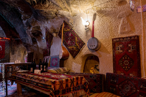 Turkish tea house interior with traditional Turkish musical instruments and decorations in a cave, Cappadocia, Turkey