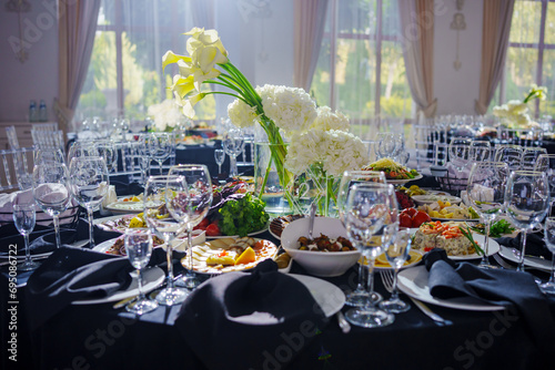 Beautifully set banquet table with black tablecloth. S