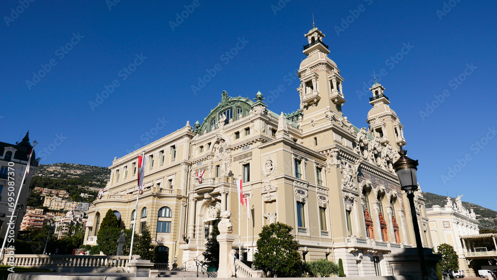 Obraz premium Stunning summer view of Monaco's iconic buildings next to the casino. Architectural elegance meets vibrant summer life, capturing the essence of luxury and charm in this Mediterranean gem.