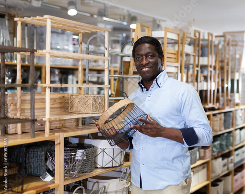 Man with metal basket box at hardware store