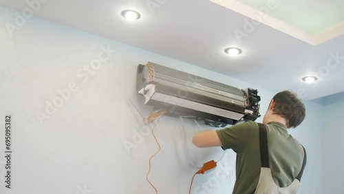 Worker in uniform, install air conditioning. Time lapse. photo