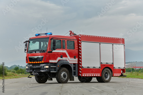 In this captivating scene  a state-of-the-art firetruck  equipped with advanced rescue technology  stands ready with its skilled firefighting team  prepared to intervene and respond rapidly to