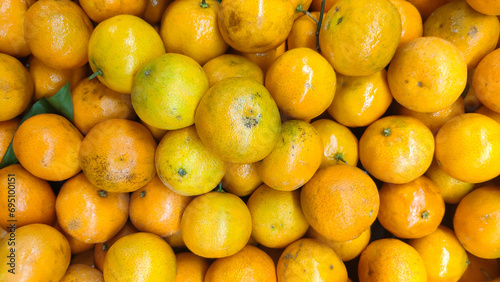 Ripe tangerines on the market. Citrus fruits background. 