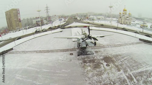 Attack-plane IL-2 on pedestal at round square with traffic  photo