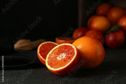 Fototapeta Naklejka Na Ścianę i Meble -  Tasty blood orange fruits on dark background