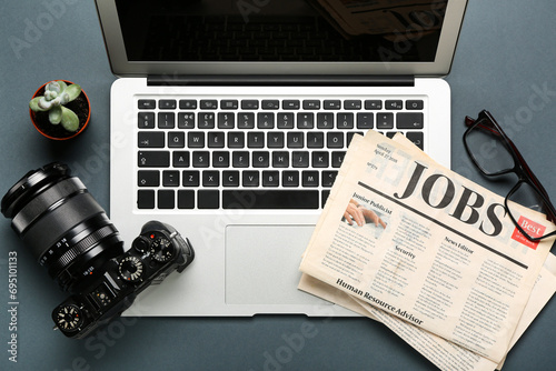 Laptop with newspapers, eye...
