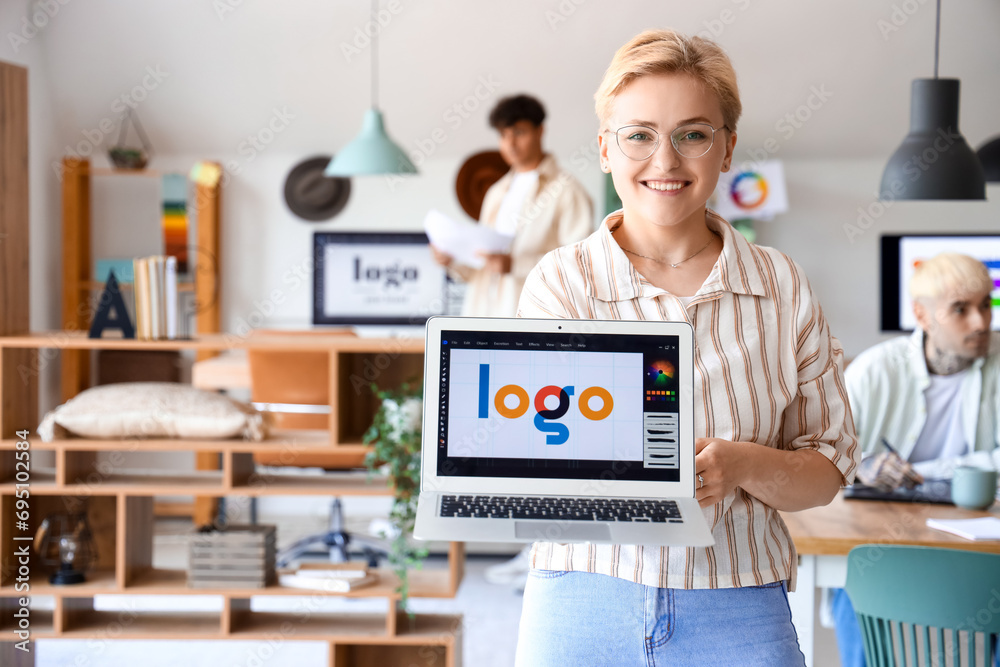 Fototapeta premium Female graphic designer working with laptop in office