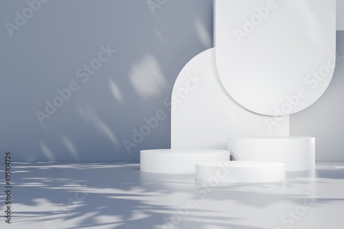 3d Abstract white room with realistic white cylinder pedestal podium set and leaf shadow overlay. Minimal design scene for stage product display presentation. Geometric platform.3D render illustration photo