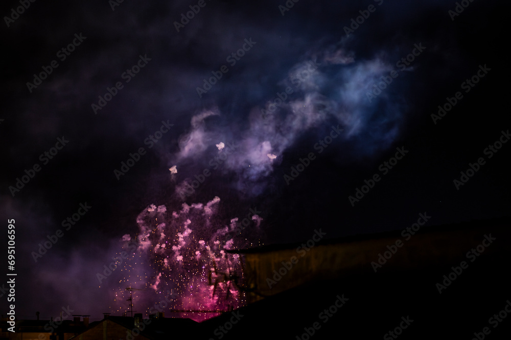 Traditional Fireworks exploding on a black dark sky