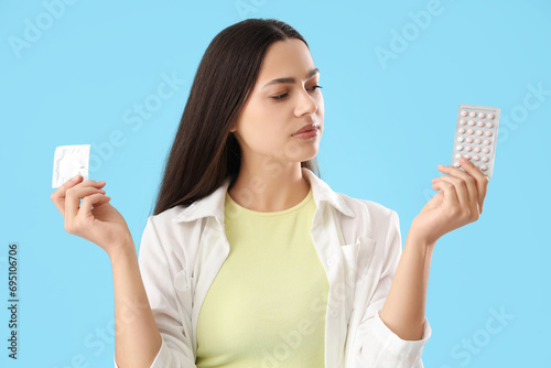 Young woman with condom and...