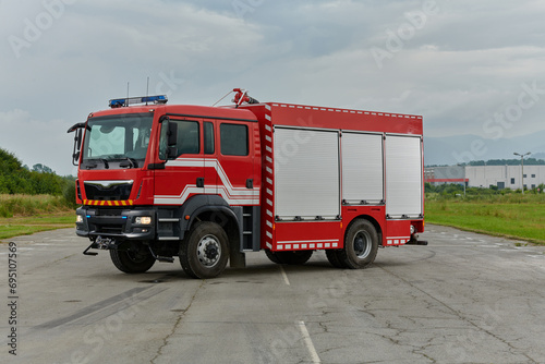 In this captivating scene  a state-of-the-art firetruck  equipped with advanced rescue technology  stands ready with its skilled firefighting team  prepared to intervene and respond rapidly to