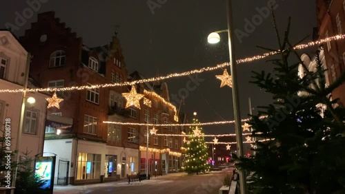  Decorated for Christmas holidays, Denmark, Copenhagen , Viborg, Shopping street in historical center of Aarhus decorated for New Year holidays, Pedestrians Christmas shopping on Stroget at night. photo