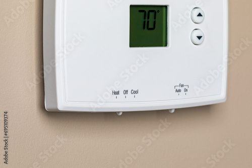 Thermostat for home furnace and air conditioner. Utility bill savings, energy cost and conservation concept photo