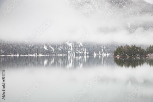 foggy lake in winter snowfall