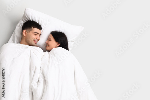 Young couple with pillow an...
