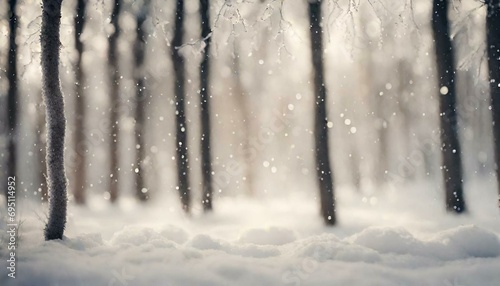 Blurry image of a winter forest, small snowdrifts and light snowfall - a beautiful winter-themed background wide format