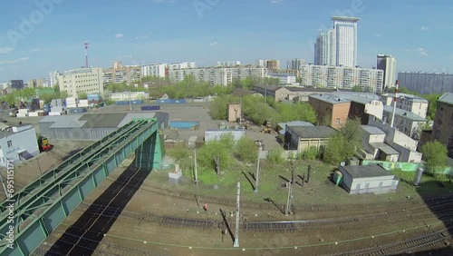 Pipeline of boiler room above railway in city at sunny day photo