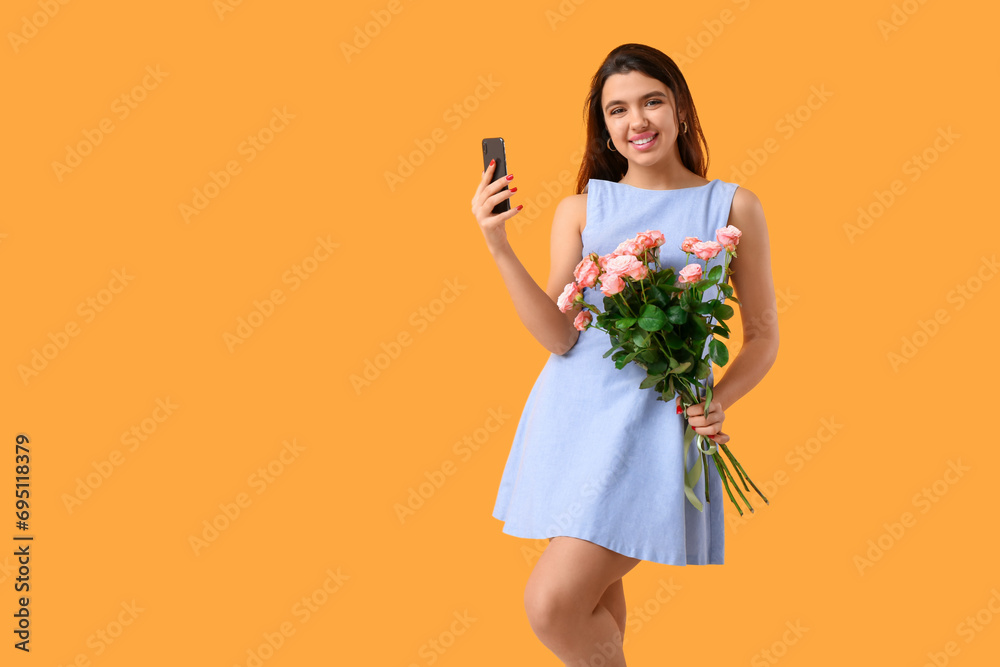 Young woman with mobile phone and roses on yellow background. Online dating concept Young woman with mobile phone and roses on yellow background. Online dating concept