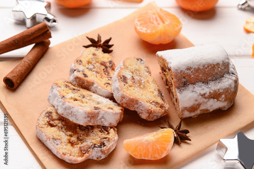 Composition with tasty Christmas stollen on white wooden background