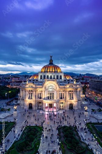 Aerial view of illuminated The Palace of Fine Arts know as "Palacio de Bellas Artes" cultural center in Mexico City, built for Centennial of the War of Independence in 1910 under blue sky at night