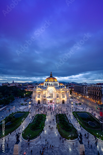 Aerial view of illuminated The Palace of Fine Arts know as "Palacio de Bellas Artes" cultural center in Mexico City, built for Centennial of the War of Independence in 1910 under blue sky at night