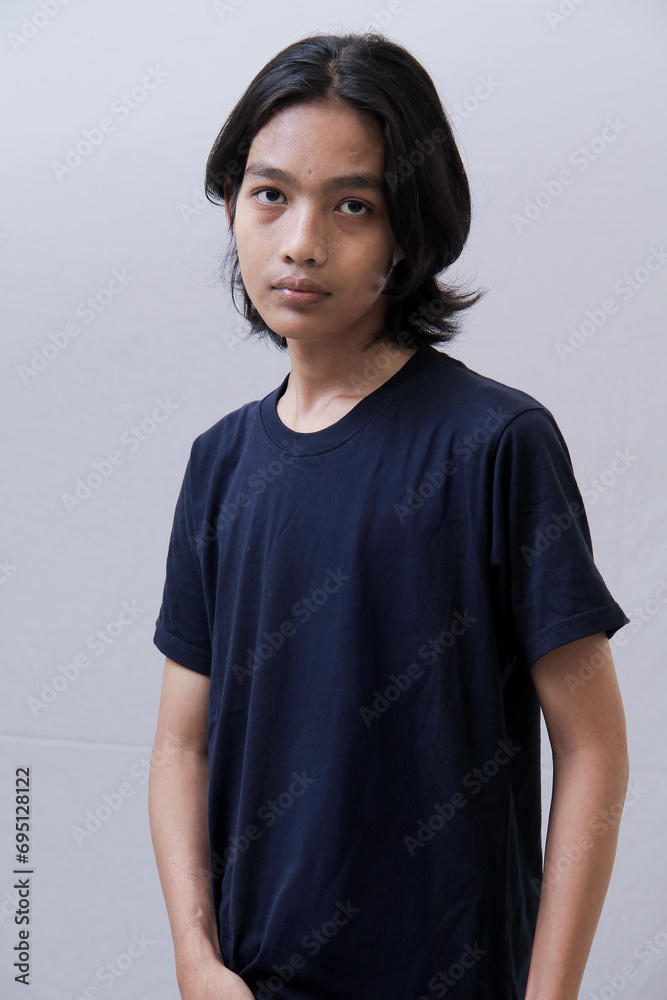 Clothing model. Young Asian man with long curly hair close up shot isolated on white. Clothing model. Young Asian man with long curly hair close up shot isolated on white.