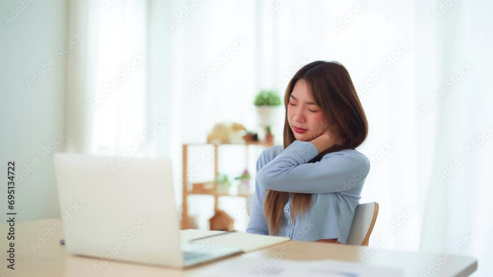 Office syndrome concept. Young asian woman feeling pain in neck and shoulder after working on computer laptop for a long time. She stretches to relax her muscles Office syndrome concept. Young asian woman feeling pain in neck and shoulder after working on computer laptop for a long time. She stretches to relax her muscles