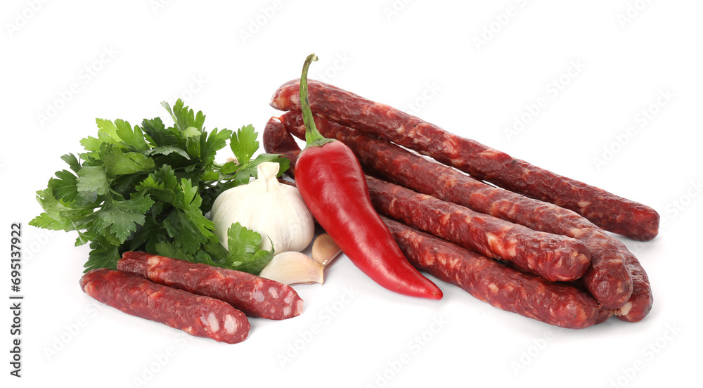 Thin dry smoked sausages and different spices isolated on white Thin dry smoked sausages and different spices isolated on white