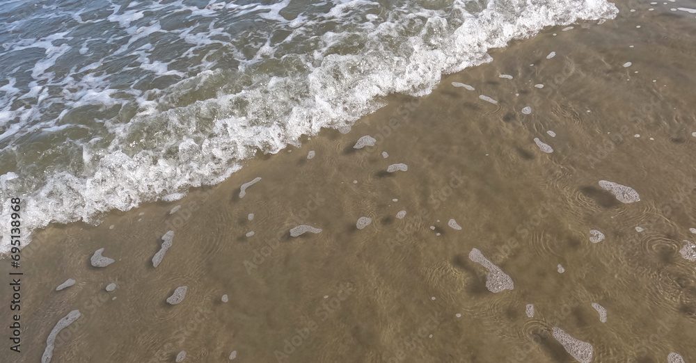 beach in the summer. beach water with foam. details of nature. beach details. beach in the summer. beach water with foam. details of nature. beach details.