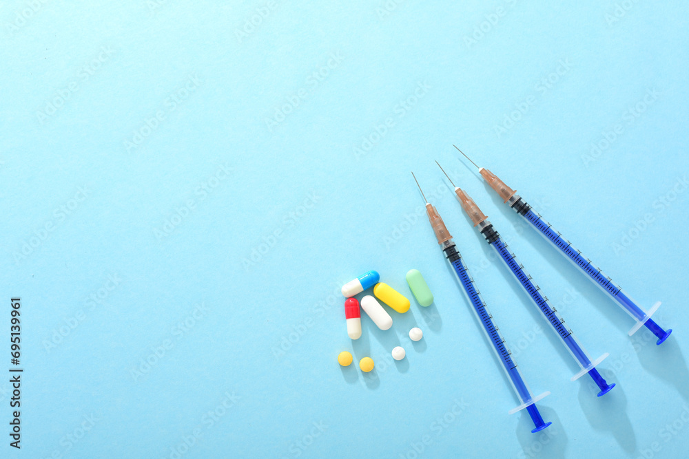 Needle cartridges and tablets on a blue background Needle cartridges and tablets on a blue background