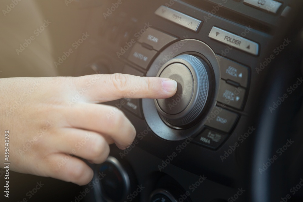 Close up of woman hand pressing button on the car's dashboard. Close up of woman hand pressing button on the car's dashboard.