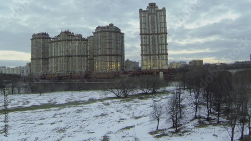 Dwelling complex on river shore at evening. Aerial view photo