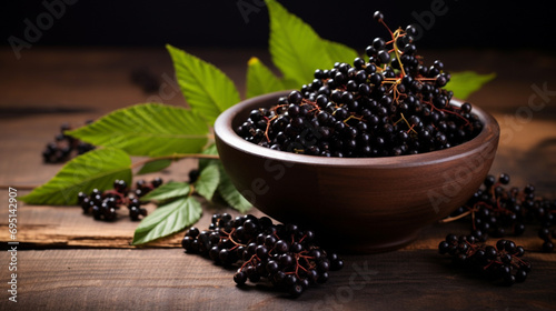 Black elderberries (Sambucus nigra) in a bowl and some berries on rustic wooden table. generative ai photo