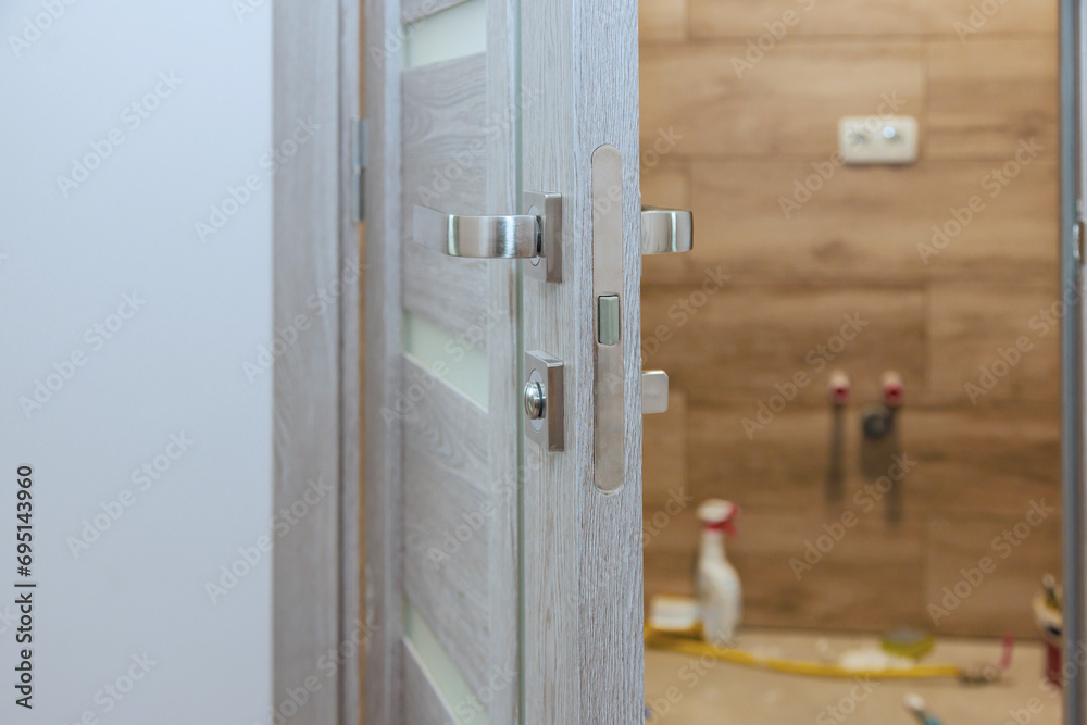 Handyman installed lock handles at wooden door